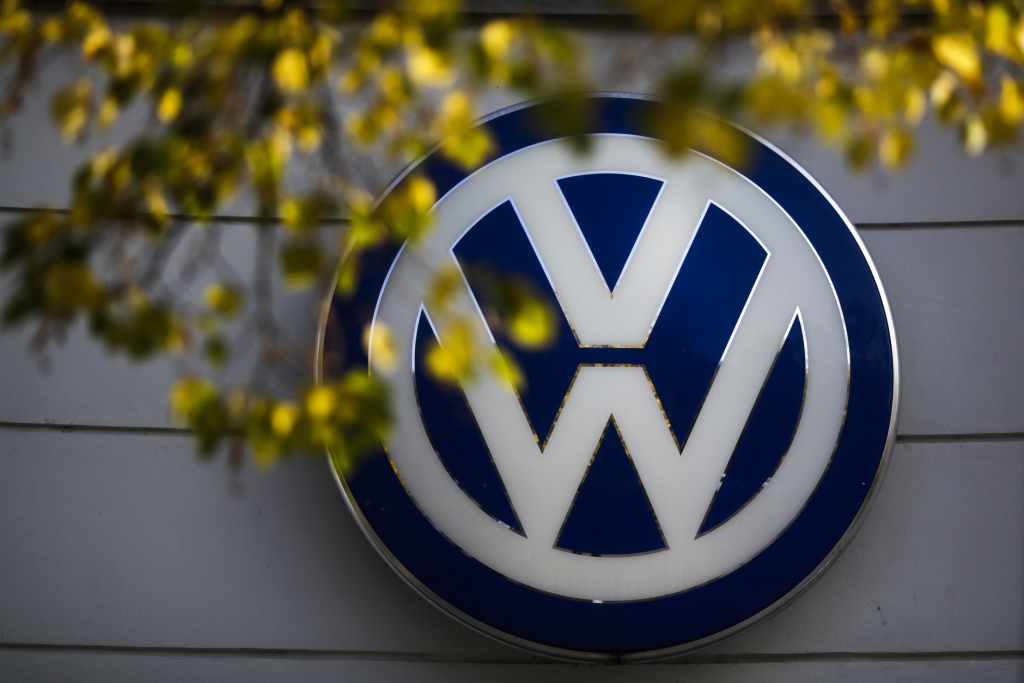 FILE - In this Oct. 5, 2015, file photo, the VW sign of Germany's Volkswagen car company is displayed at the building of a company's retailer in Berlin. Volkswagen Truck & Bus, an arm of the German automaker Volkswagen, is buying a minority stake in Navistar. The two companies also said Tuesday, Sept. 6, 2016, that they will enter a procurement joint venture that will help source parts for both businesses. (AP Photo/Markus Schreiber, File)