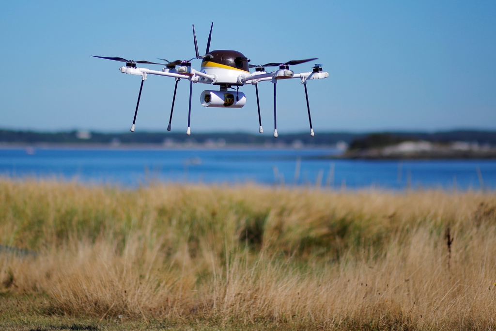 A drone, made by CyPhy Works, carries a UPS package on Children's Island off the coast of Beverly, Massachusetts, U.S. September 22, 2016, during UPS's demonstration of a drone making a commercial delivery of a package to a remote or difficult-to-access location. Picture taken September 22, 2016. REUTERS/Brian Snyder